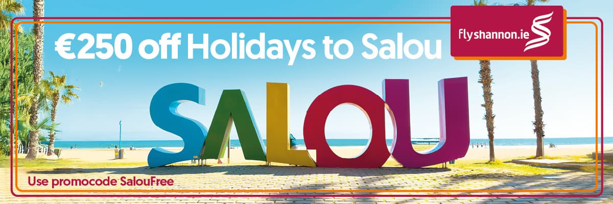 Promotional banner advertising €250 off holidays to Salou, showing large colorful “SALOU” letters on a sunny beach with palm trees, FlyShannon.ie logo, and text reading “Use promocode SalouFree.